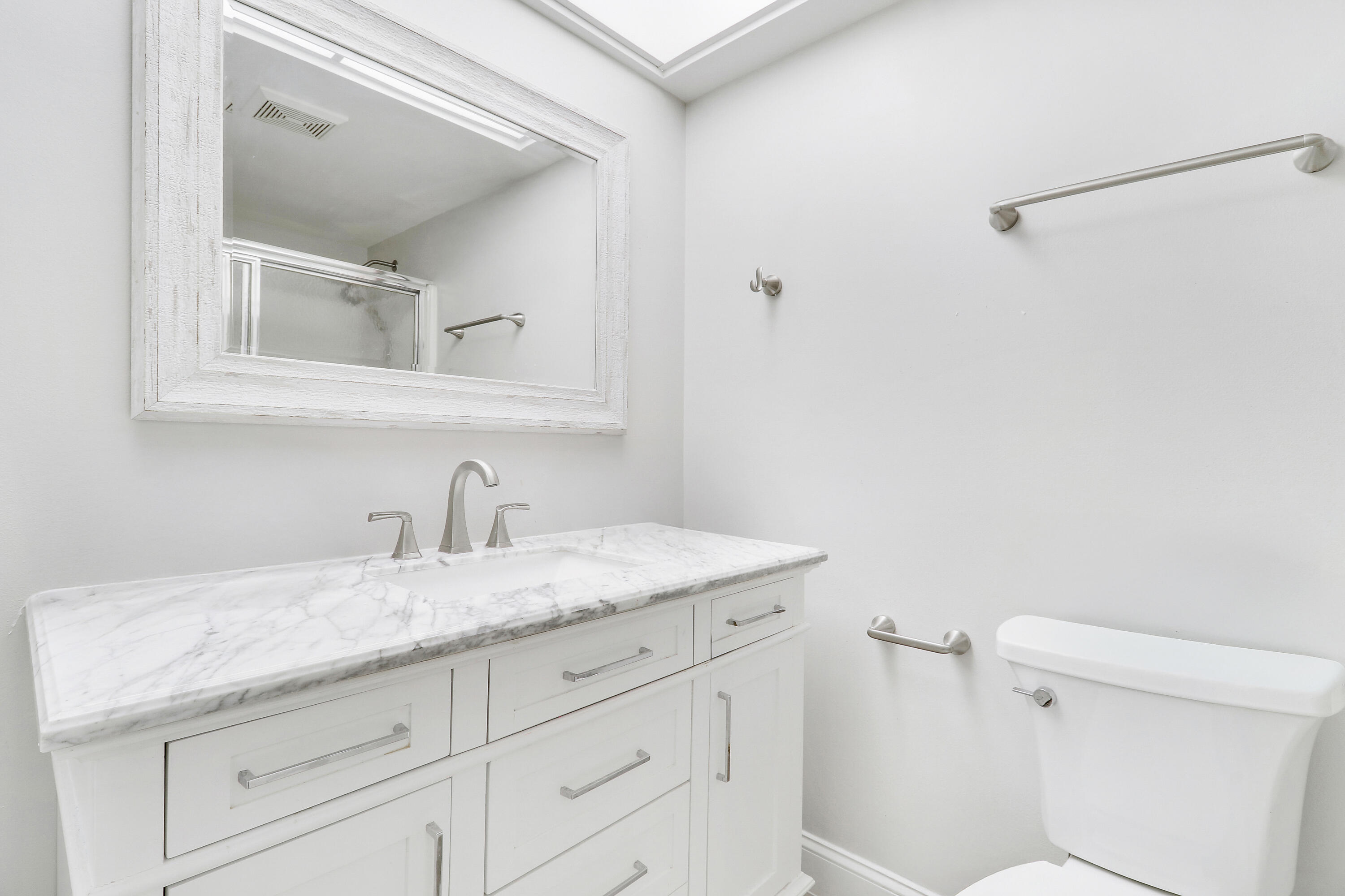 1200 Southeast Parkview Place, Unit F3 Stuart, FL 34994 - Photo 11 of 32 a bathroom with a granite countertop sink and a mirror