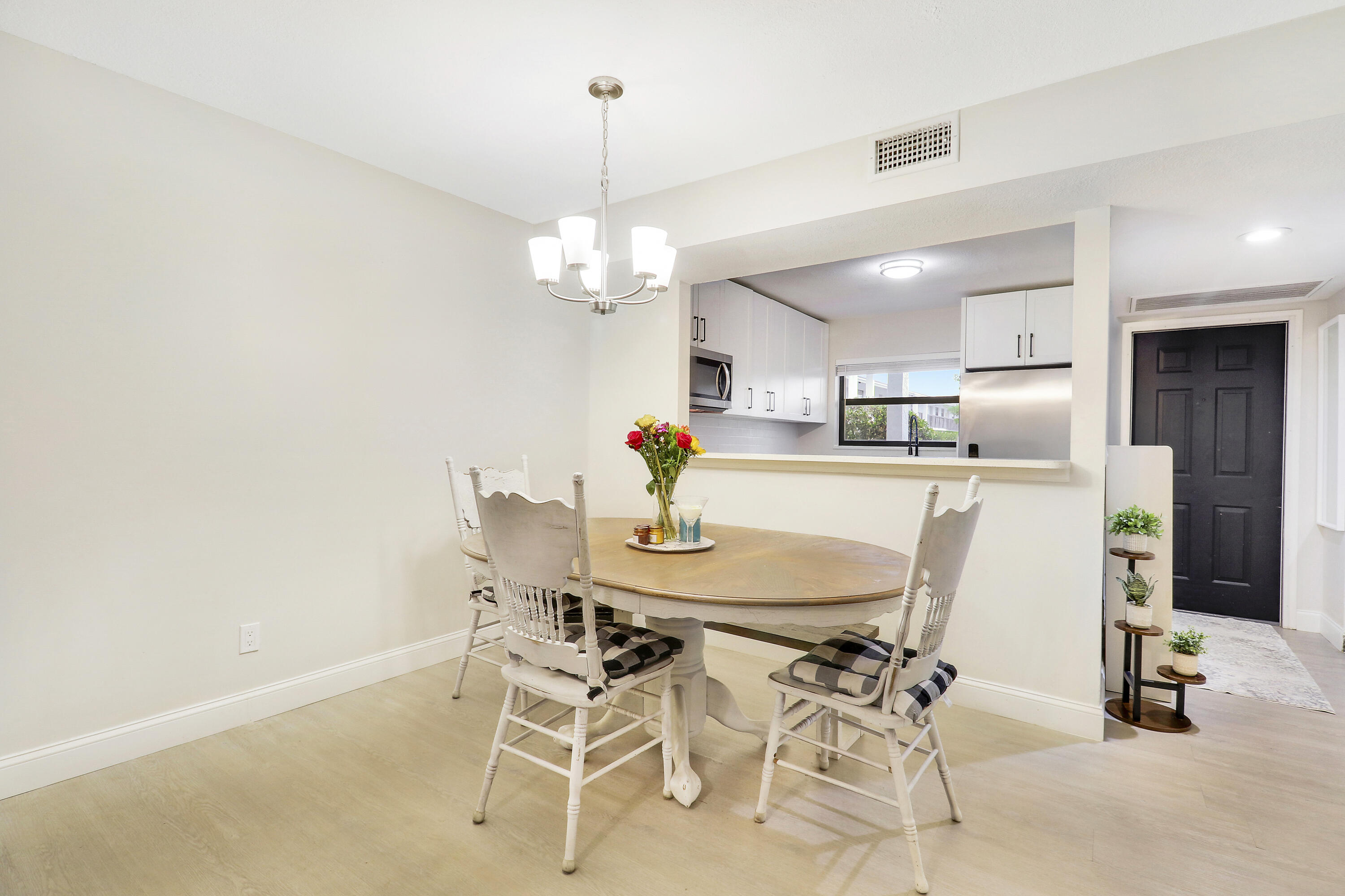 1200 Southeast Parkview Place, Unit F3 Stuart, FL 34994 - Photo 13 of 32 a view of a dining room with furniture and chandelier