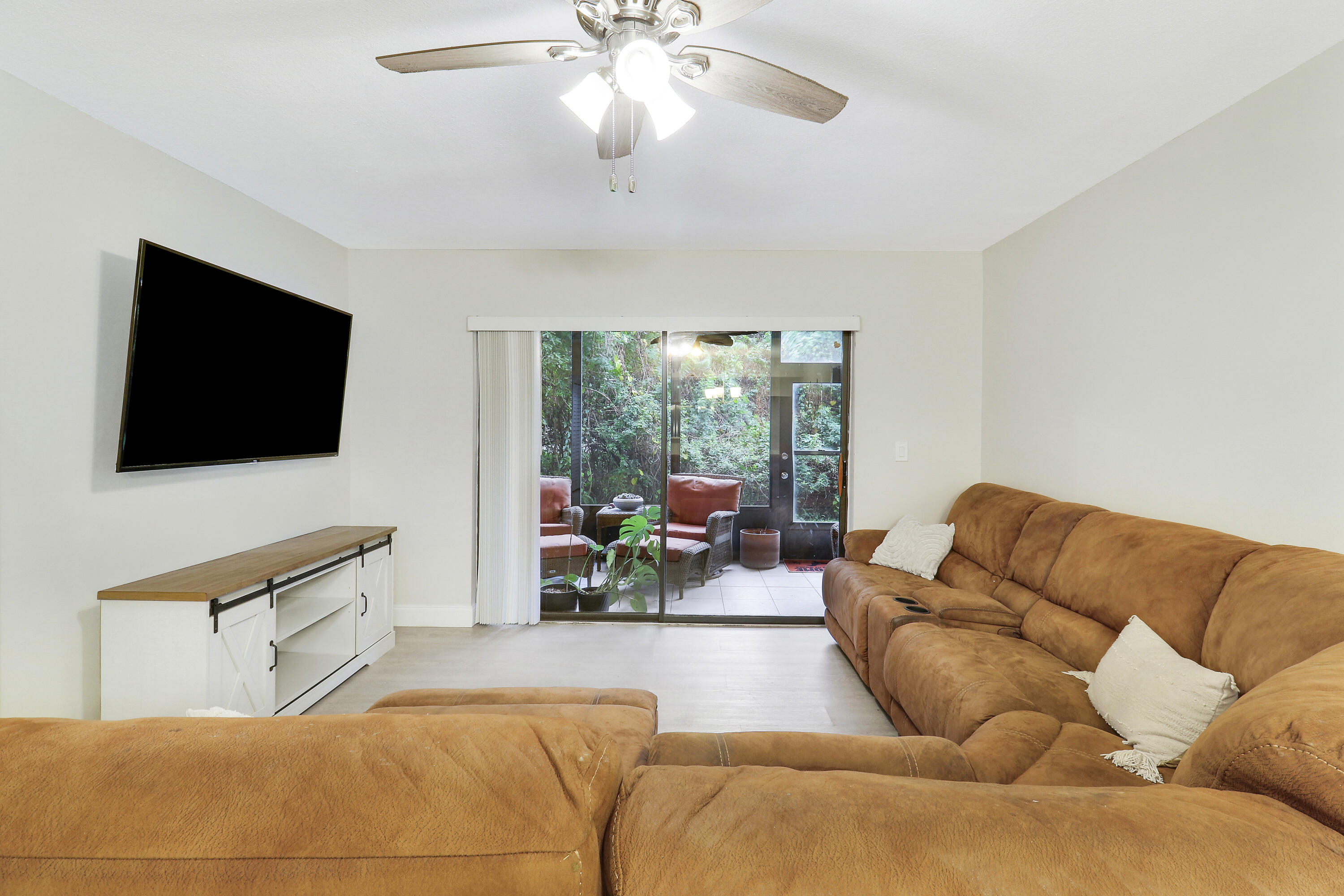 1200 Southeast Parkview Place, Unit F3 Stuart, FL 34994 - Photo 16 of 32 a living room with furniture and a flat screen tv