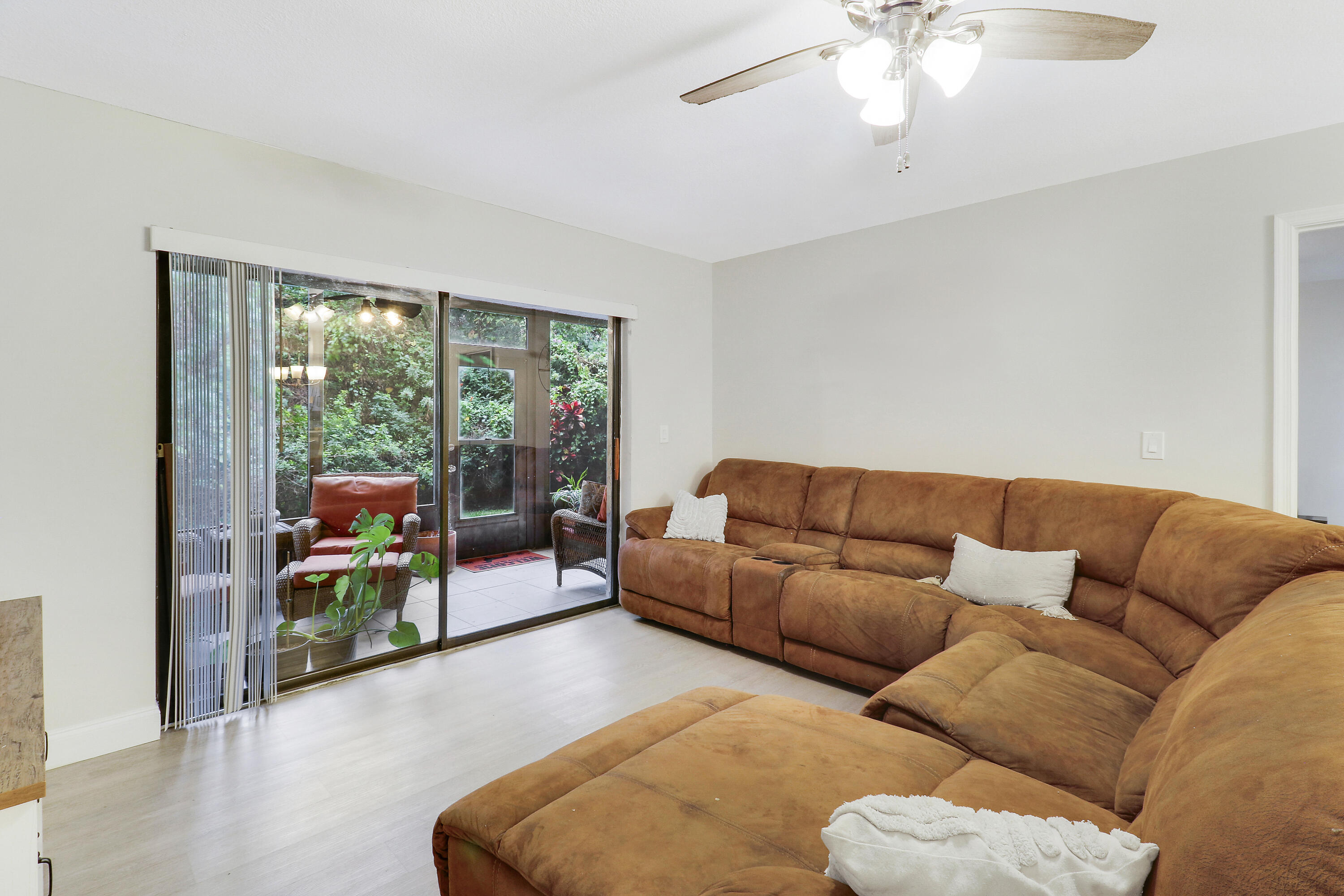 1200 Southeast Parkview Place, Unit F3 Stuart, FL 34994 - Photo 17 of 32 a living room with furniture and a chandelier