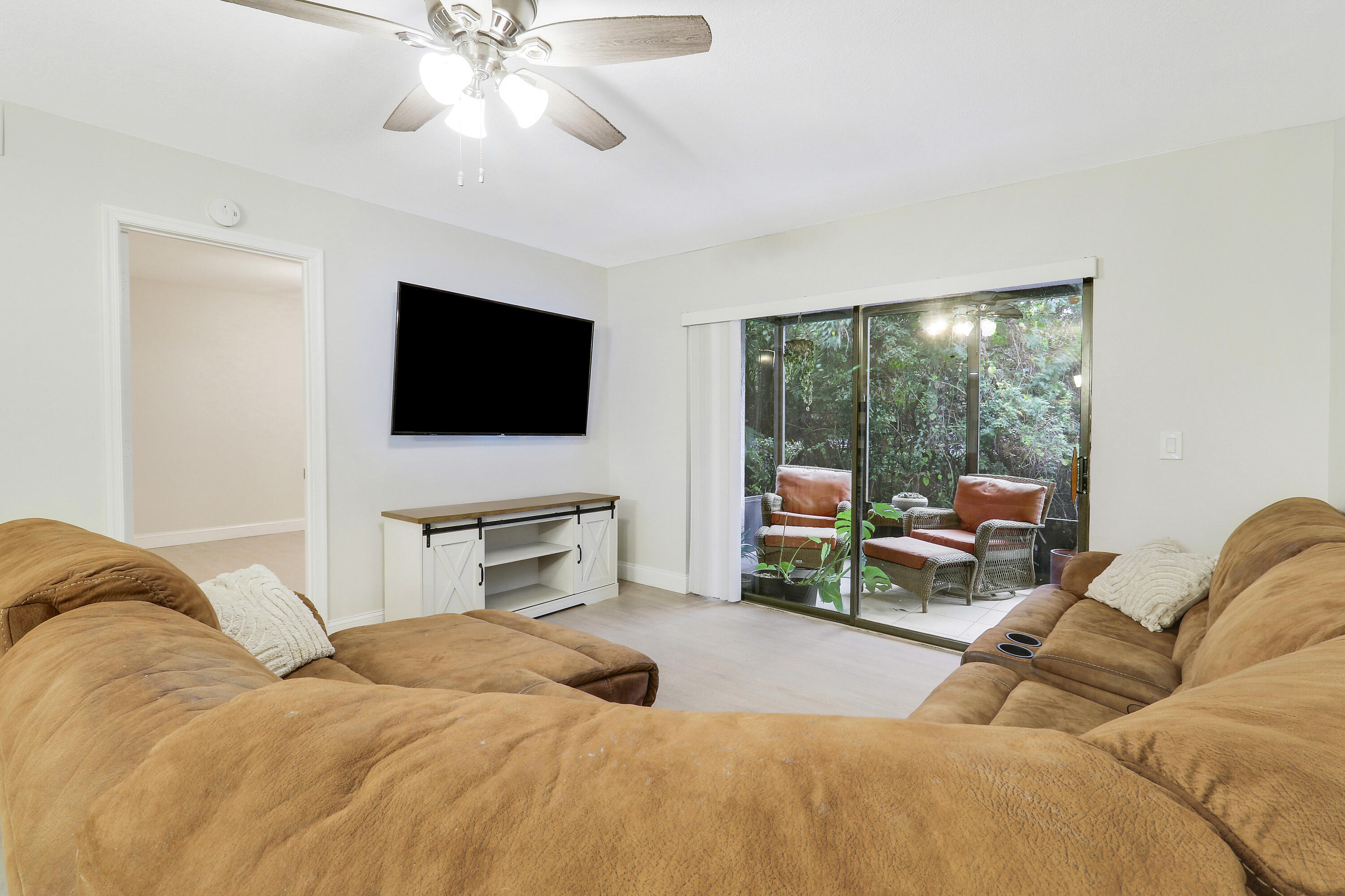 1200 Southeast Parkview Place, Unit F3 Stuart, FL 34994 - Photo 18 of 32 a bedroom with a bed and glass window