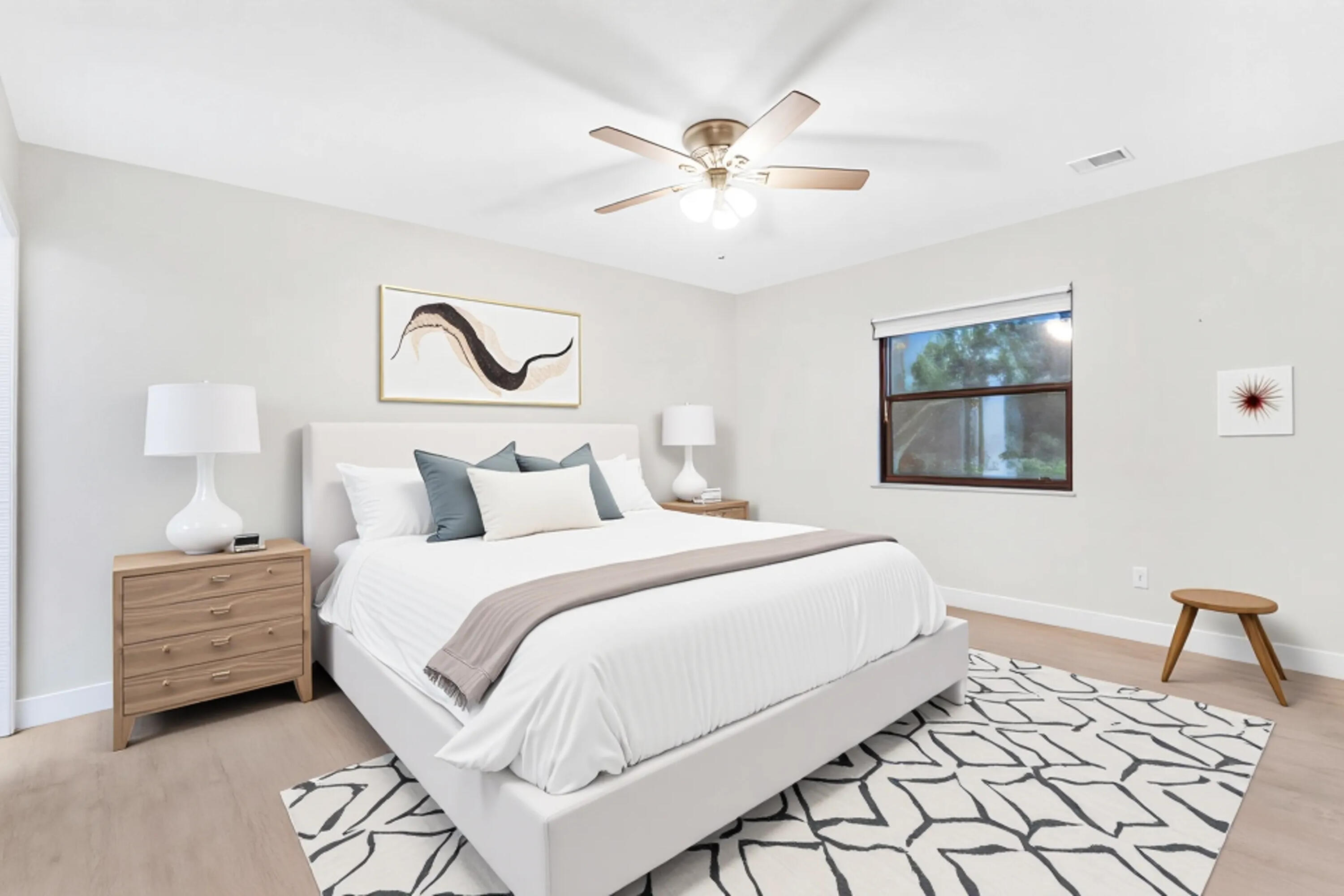 1200 Southeast Parkview Place, Unit F3 Stuart, FL 34994 - Photo 20 of 32 a bedroom with a bed and a painting on the wall