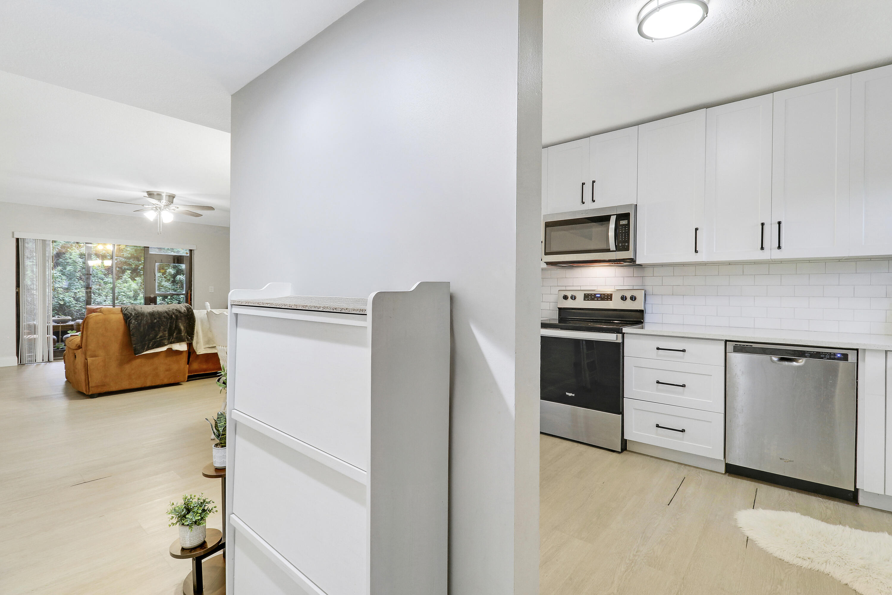 1200 Southeast Parkview Place, Unit F3 Stuart, FL 34994 - Photo 3 of 32 a kitchen with stainless steel appliances a refrigerator stove and sink