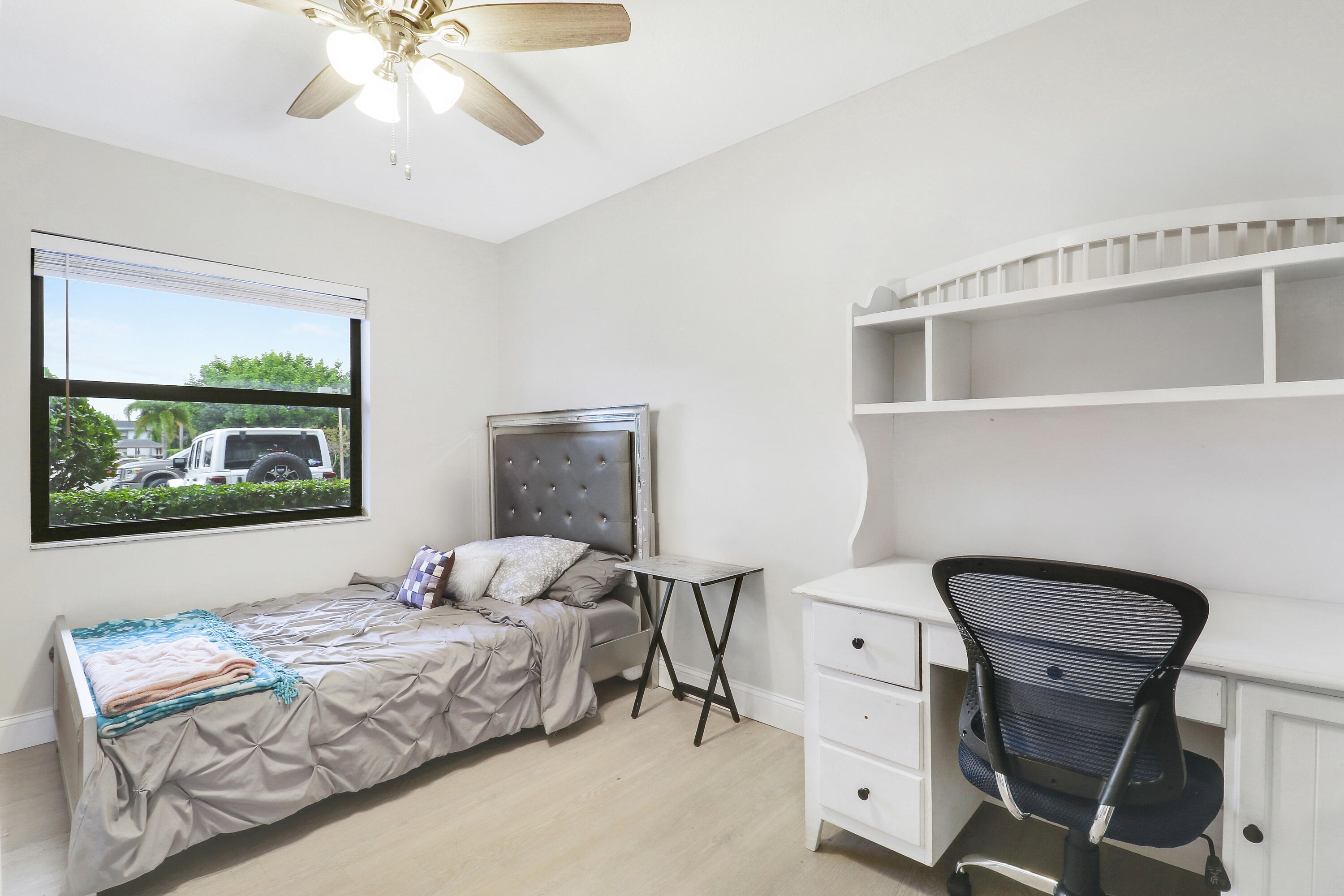 1200 Southeast Parkview Place, Unit F3 Stuart, FL 34994 - Photo 9 of 32 a bedroom with a bed and a chandelier
