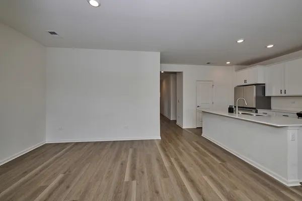 a view of kitchen with sink microwave refrigerator and stove