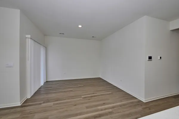 a view of room with wooden floor