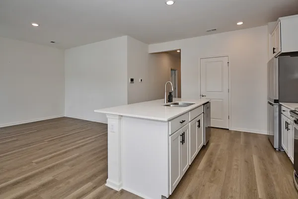 a kitchen with a sink stove and refrigerator