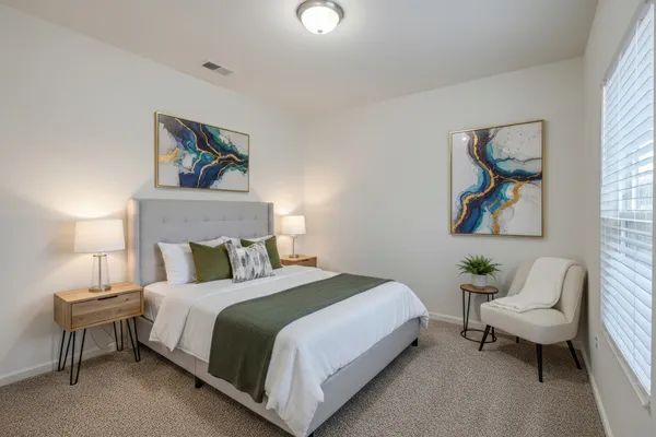 a bedroom with a bed and a lamp