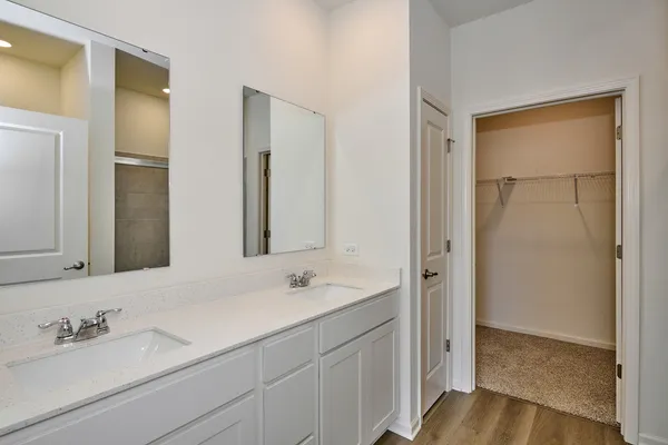 a bathroom with a double vanity sink and mirror