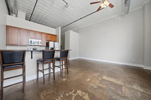 a kitchen with stainless steel appliances granite countertop a stove a refrigerator and a sink