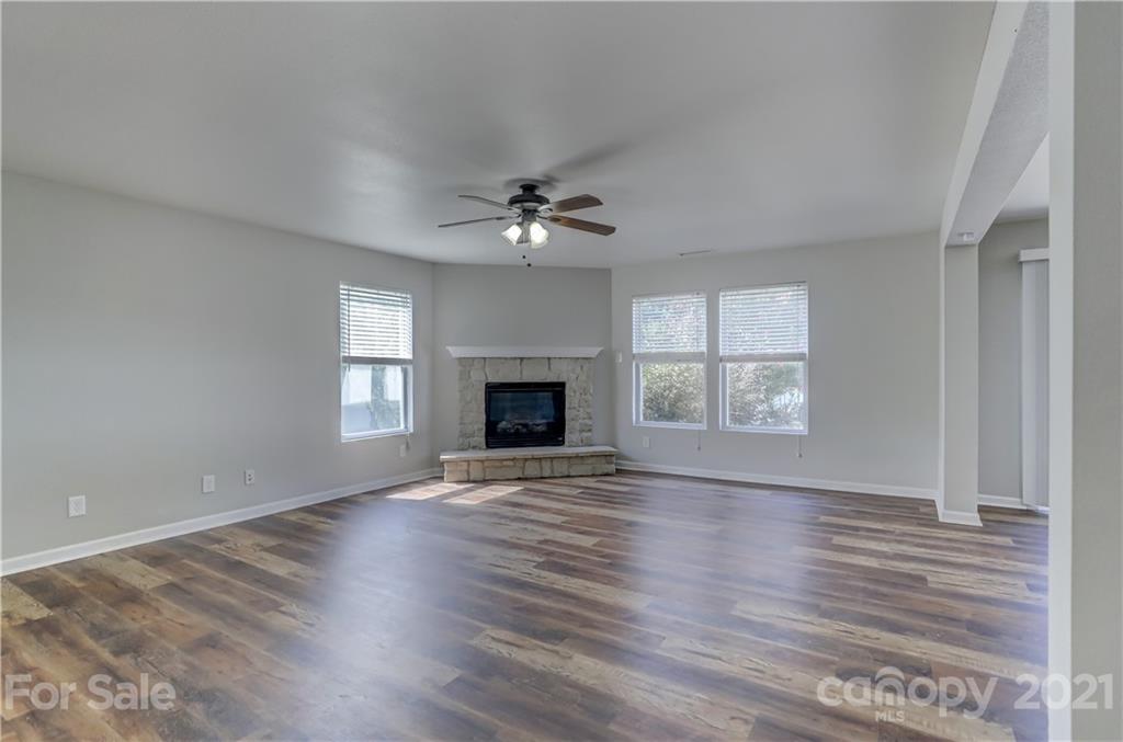 2170 Durand Road, Unit 40 Fort Mill, SC 29715 - Photo 14 of 48 an empty room with wooden floor fireplace and windows