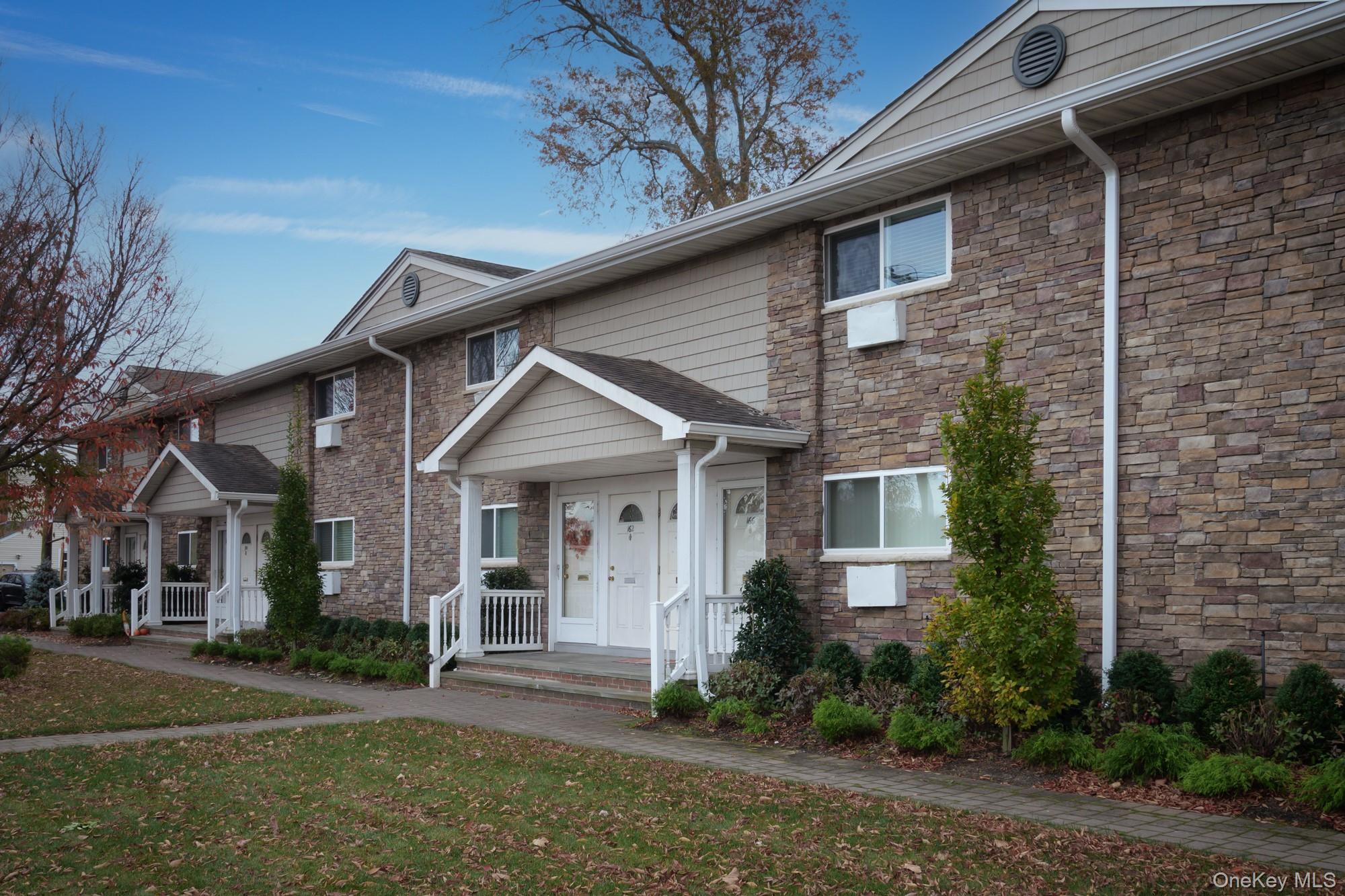 80 Friendly Court, Unit FC80 Babylon, NY 11702 - Photo 2 of 2 a front view of a house with garden