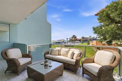 a balcony with furniture and a lake view