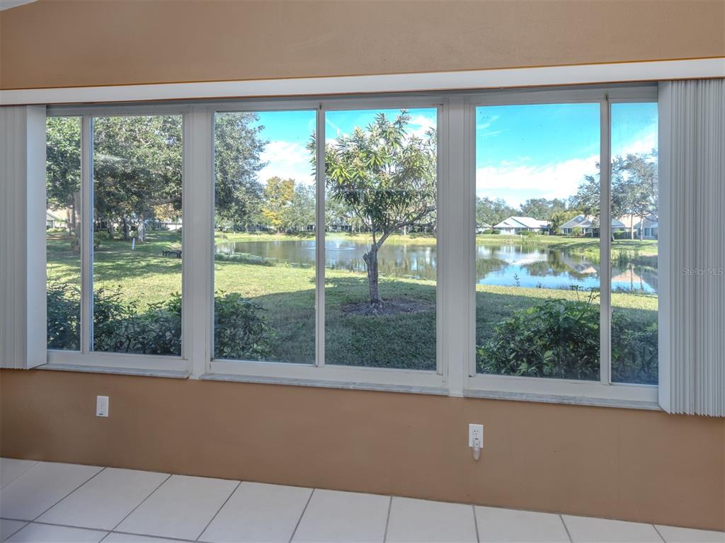 561 Clubside Circle, Unit 58 Venice, FL 34293 - Photo 11 of 44 a view of an empty room with large windows and view of balcony