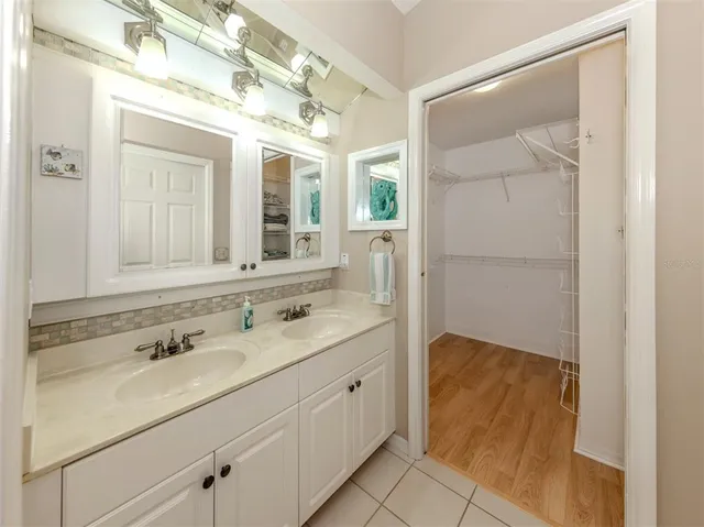 a spacious bathroom with a double vanity sink and mirror