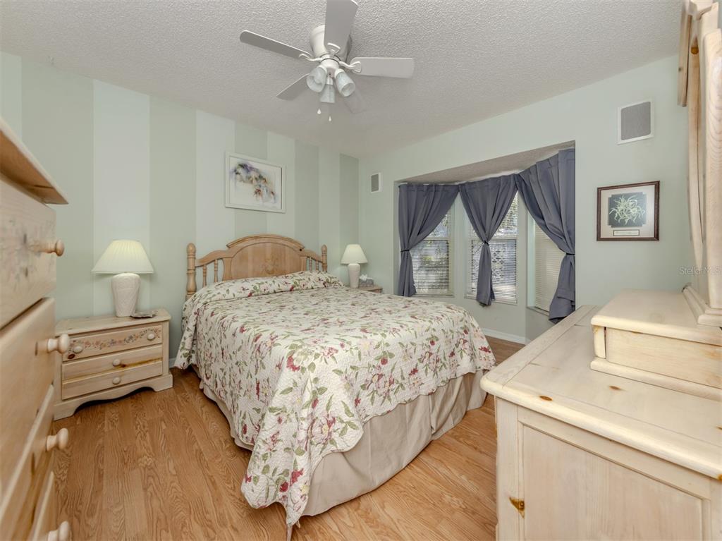561 Clubside Circle, Unit 58 Venice, FL 34293 - Photo 17 of 44 a bedroom with a bed and a dresser