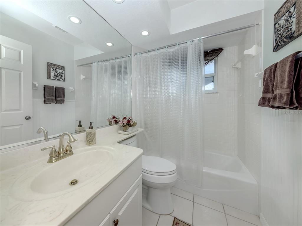 561 Clubside Circle, Unit 58 Venice, FL 34293 - Photo 18 of 44 a bathroom with a sink toilet and shower