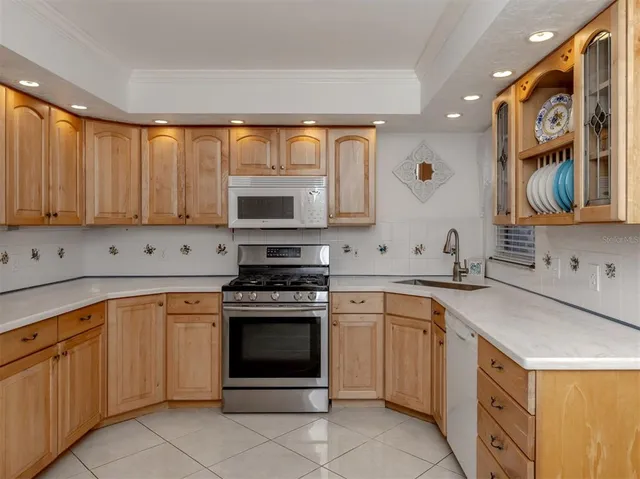 a kitchen with cabinets appliances and a sink