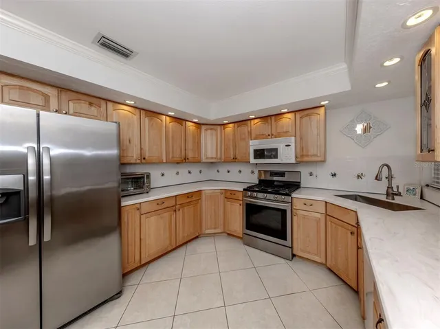 a kitchen with stainless steel appliances granite countertop a refrigerator sink and cabinets