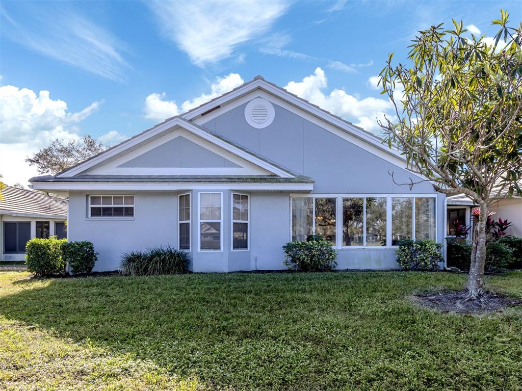 561 Clubside Circle, Unit 58 Venice, FL 34293 - Photo 25 of 44 a front view of a house with garden