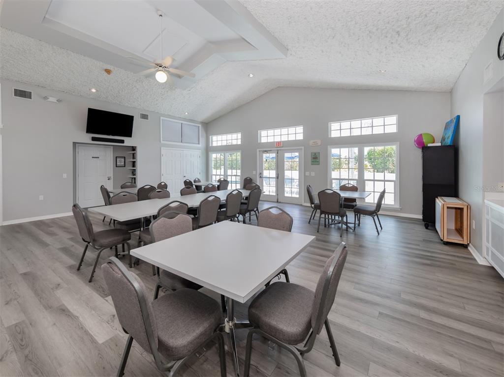561 Clubside Circle, Unit 58 Venice, FL 34293 - Photo 31 of 44 a view of a dining room with furniture and wooden floor