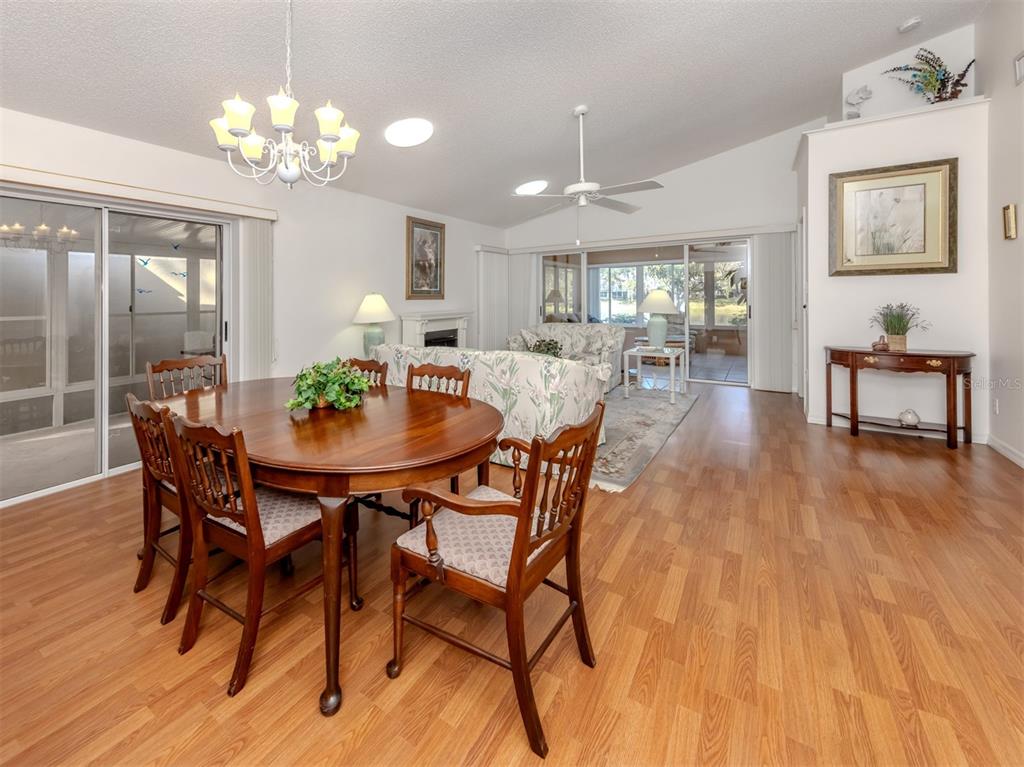 561 Clubside Circle, Unit 58 Venice, FL 34293 - Photo 4 of 44 a view of a dining room with furniture and wooden floor