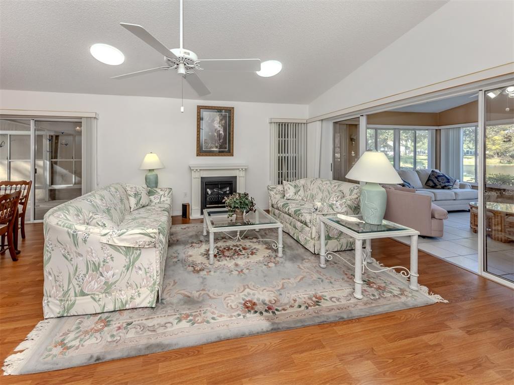 561 Clubside Circle, Unit 58 Venice, FL 34293 - Photo 6 of 44 a living room with furniture and a table