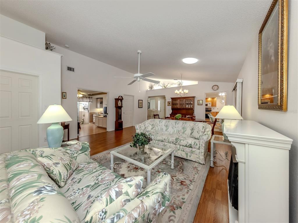 561 Clubside Circle, Unit 58 Venice, FL 34293 - Photo 8 of 44 a bed room with furniture and a chandelier