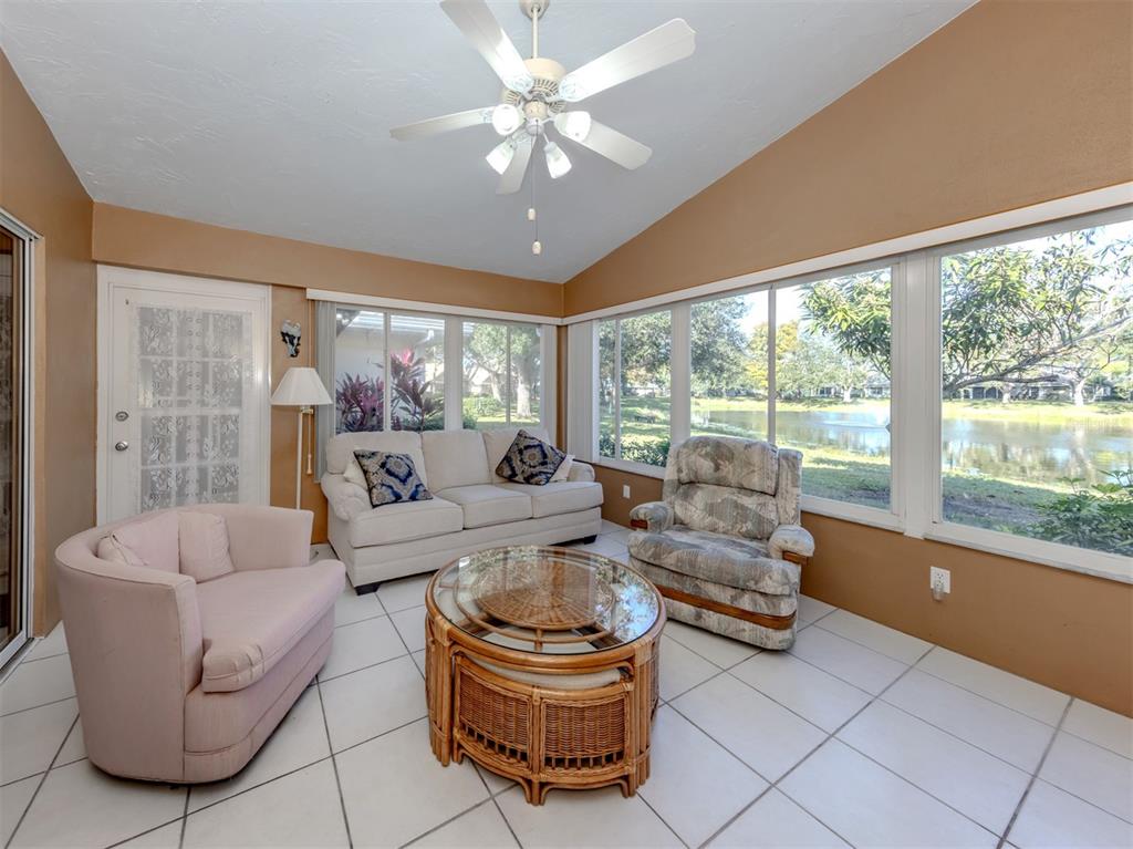 561 Clubside Circle, Unit 58 Venice, FL 34293 - Photo 9 of 44 a living room with furniture and a large window