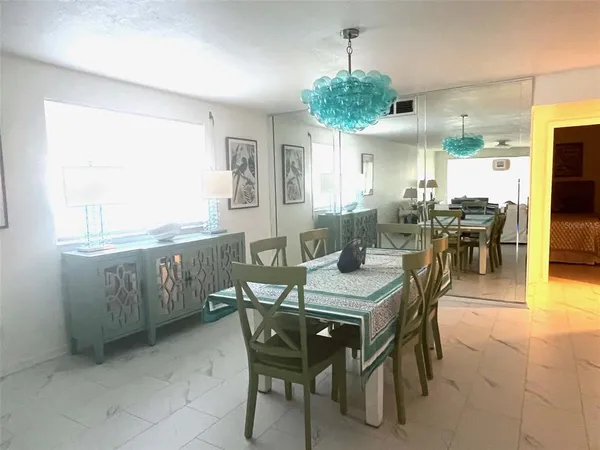 a kitchen with stainless steel appliances a refrigerator and a table