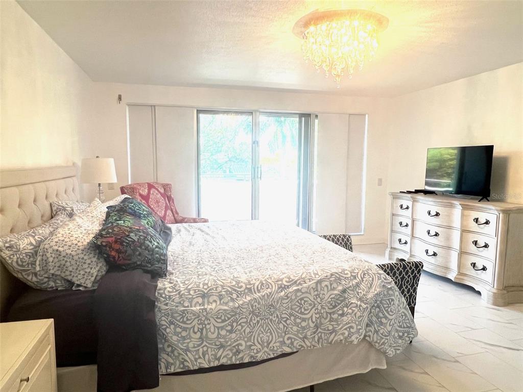 1000 Riverside Drive, Unit B104 Palmetto, FL 34221 - Photo 14 of 36 a bedroom with a bed and tv