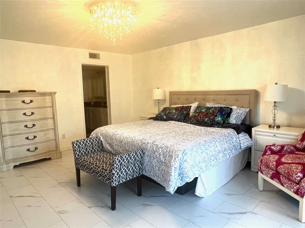 1000 Riverside Drive, Unit B104 Palmetto, FL 34221 - Photo 15 of 36 a bedroom with a bed and dresser