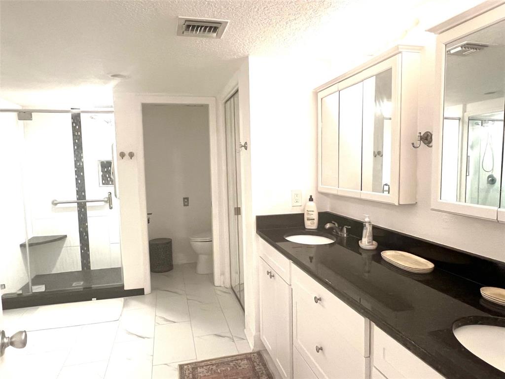 1000 Riverside Drive, Unit B104 Palmetto, FL 34221 - Photo 16 of 36 a bathroom with a granite countertop sink and a mirror