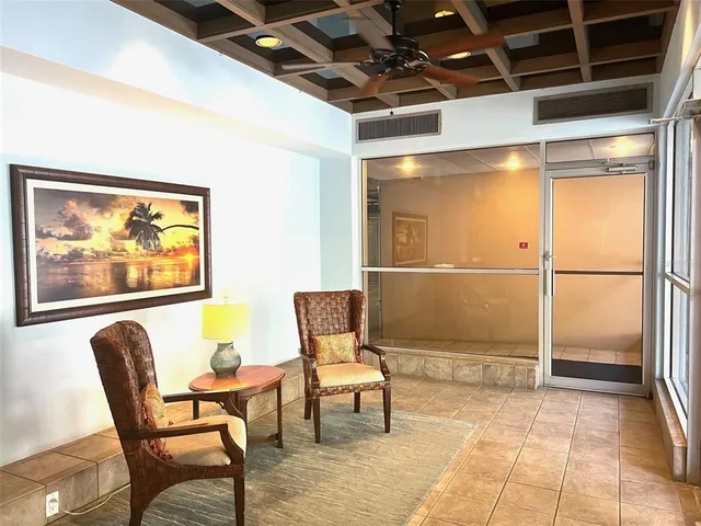 a view of a hallway with wooden floor and a dining room