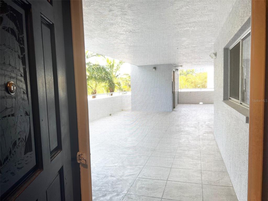 1000 Riverside Drive, Unit B104 Palmetto, FL 34221 - Photo 5 of 36 a view of a hallway with wooden floor and a dining room