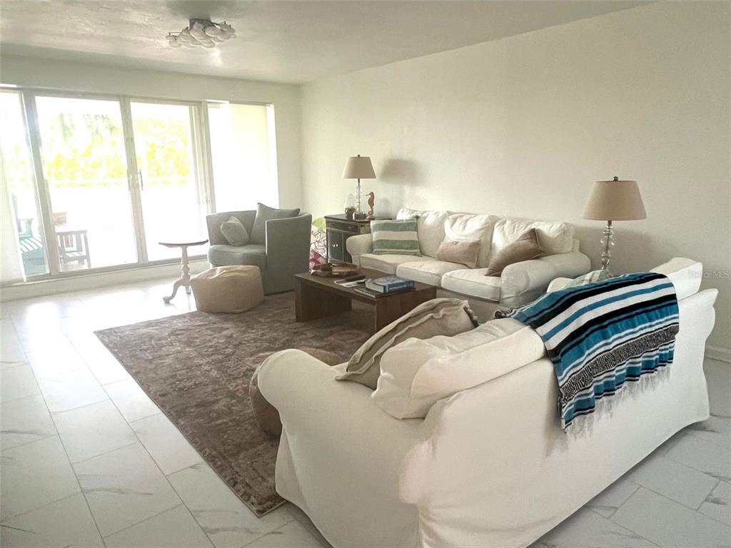 1000 Riverside Drive, Unit B104 Palmetto, FL 34221 - Photo 8 of 36 a living room with furniture and a large window