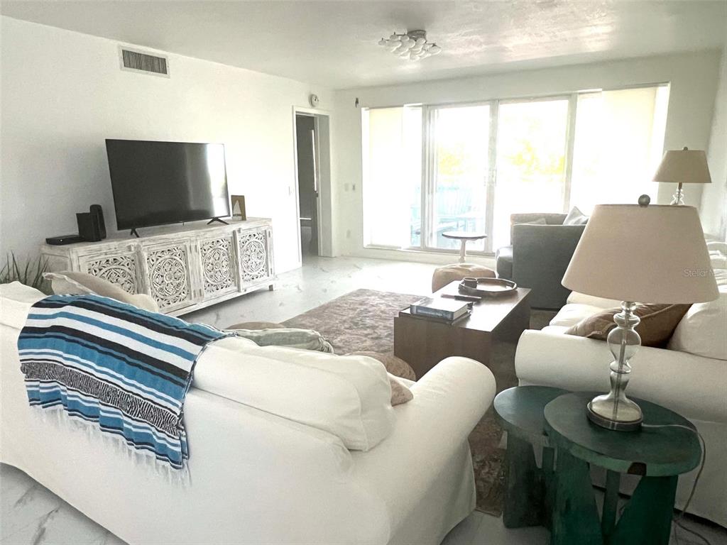 1000 Riverside Drive, Unit B104 Palmetto, FL 34221 - Photo 9 of 36 a living room with furniture and a flat screen tv