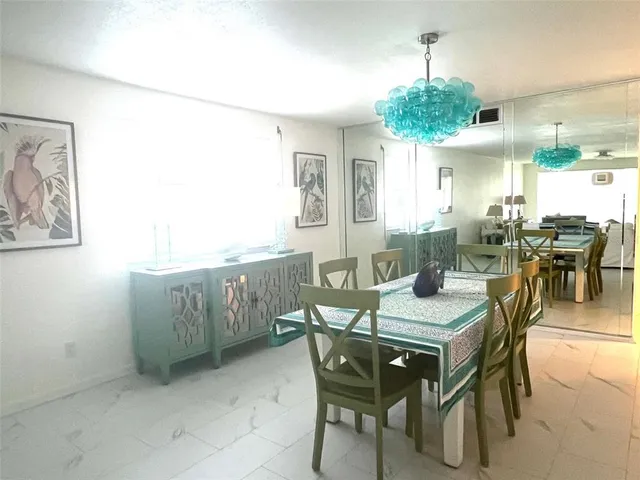 a kitchen with stainless steel appliances kitchen island granite countertop a stove top oven a sink a counter space and cabinets