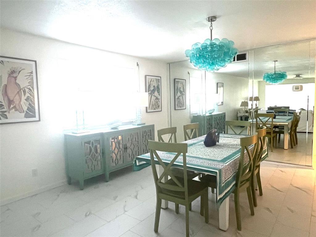 1000 Riverside Drive, Unit B104 Palmetto, FL 34221 - Photo 10 of 36 a view of a dining room with furniture and chandelier