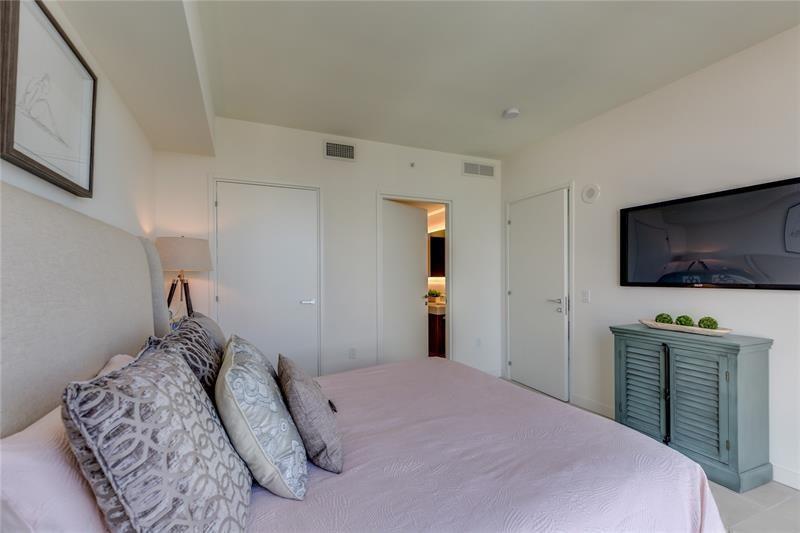 401 North Birch Road, Unit 1012 Fort Lauderdale, FL 33304 - Photo 12 of 44 a bedroom with a bed and a flat screen tv