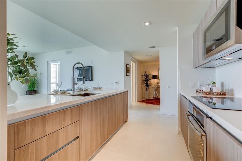 401 North Birch Road, Unit 1012 Fort Lauderdale, FL 33304 - Photo 16 of 44 a kitchen with a sink and cabinets