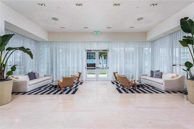 401 North Birch Road, Unit 1012 Fort Lauderdale, FL 33304 - Photo 24 of 44 a lobby with furniture and floor to ceiling window
