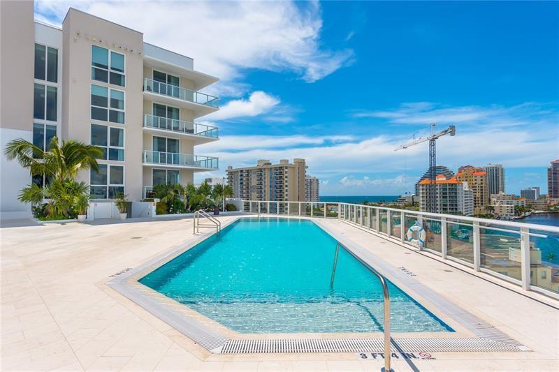 401 North Birch Road, Unit 1012 Fort Lauderdale, FL 33304 - Photo 27 of 44 a view of a swimming pool with a patio