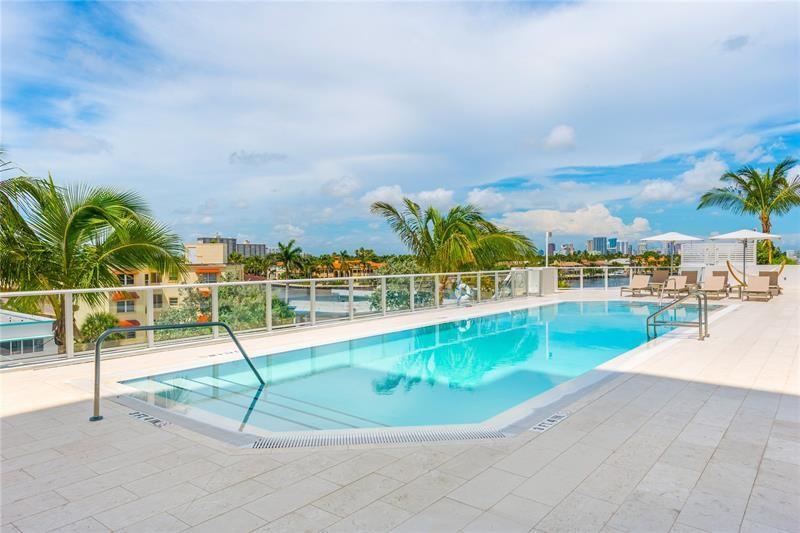 401 North Birch Road, Unit 1012 Fort Lauderdale, FL 33304 - Photo 29 of 44 a view of a swimming pool with an outdoor seating