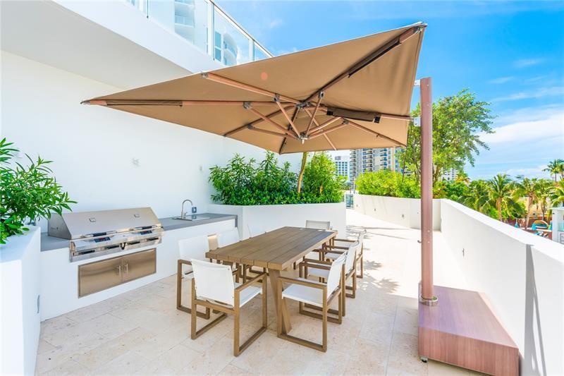 401 North Birch Road, Unit 1012 Fort Lauderdale, FL 33304 - Photo 32 of 44 a view of patio with a table and chairs under an umbrella