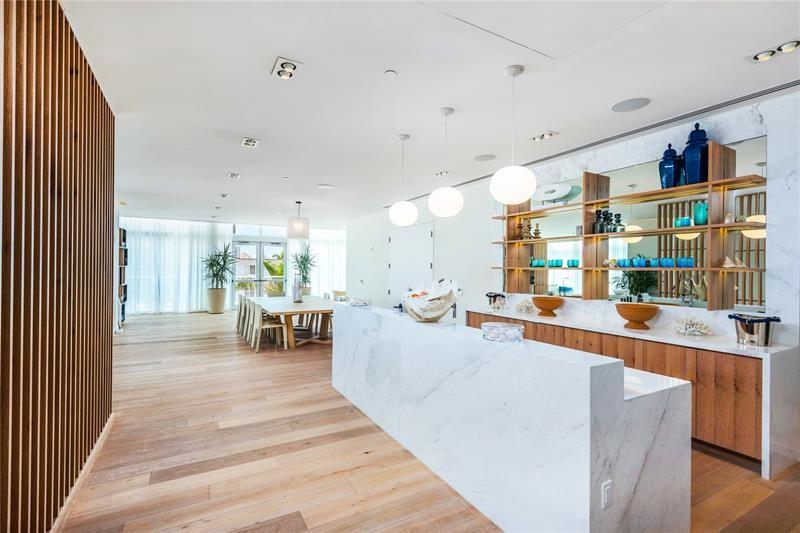 401 North Birch Road, Unit 1012 Fort Lauderdale, FL 33304 - Photo 36 of 44 a living room with stainless steel appliances furniture a rug and a kitchen view