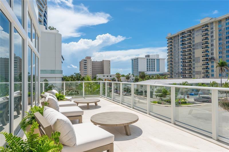 401 North Birch Road, Unit 1012 Fort Lauderdale, FL 33304 - Photo 37 of 44 a balcony with table and chairs