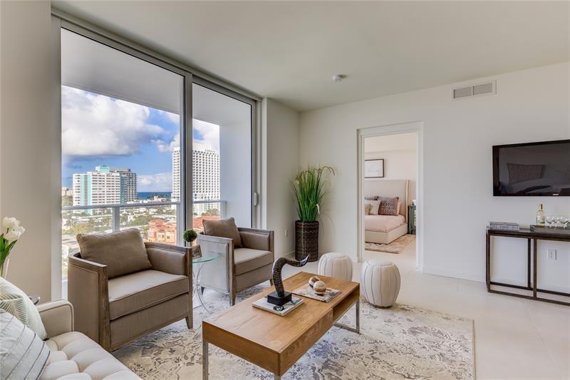 401 North Birch Road, Unit 1012 Fort Lauderdale, FL 33304 - Photo 4 of 44 a living room with furniture tv and a large window