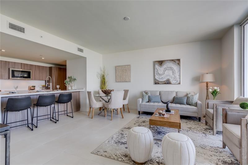 401 North Birch Road, Unit 1012 Fort Lauderdale, FL 33304 - Photo 6 of 44 a living room with furniture kitchen view and a dining table