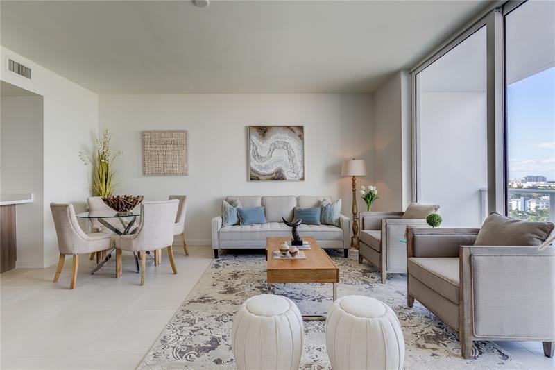 401 North Birch Road, Unit 1012 Fort Lauderdale, FL 33304 - Photo 8 of 44 a living room with furniture two large windows and a dining table